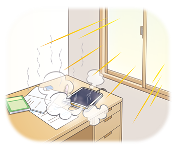 窓際の机の上に置いているタブレット端末が窓から入る日光で温められて、端末から煙が出ている様子